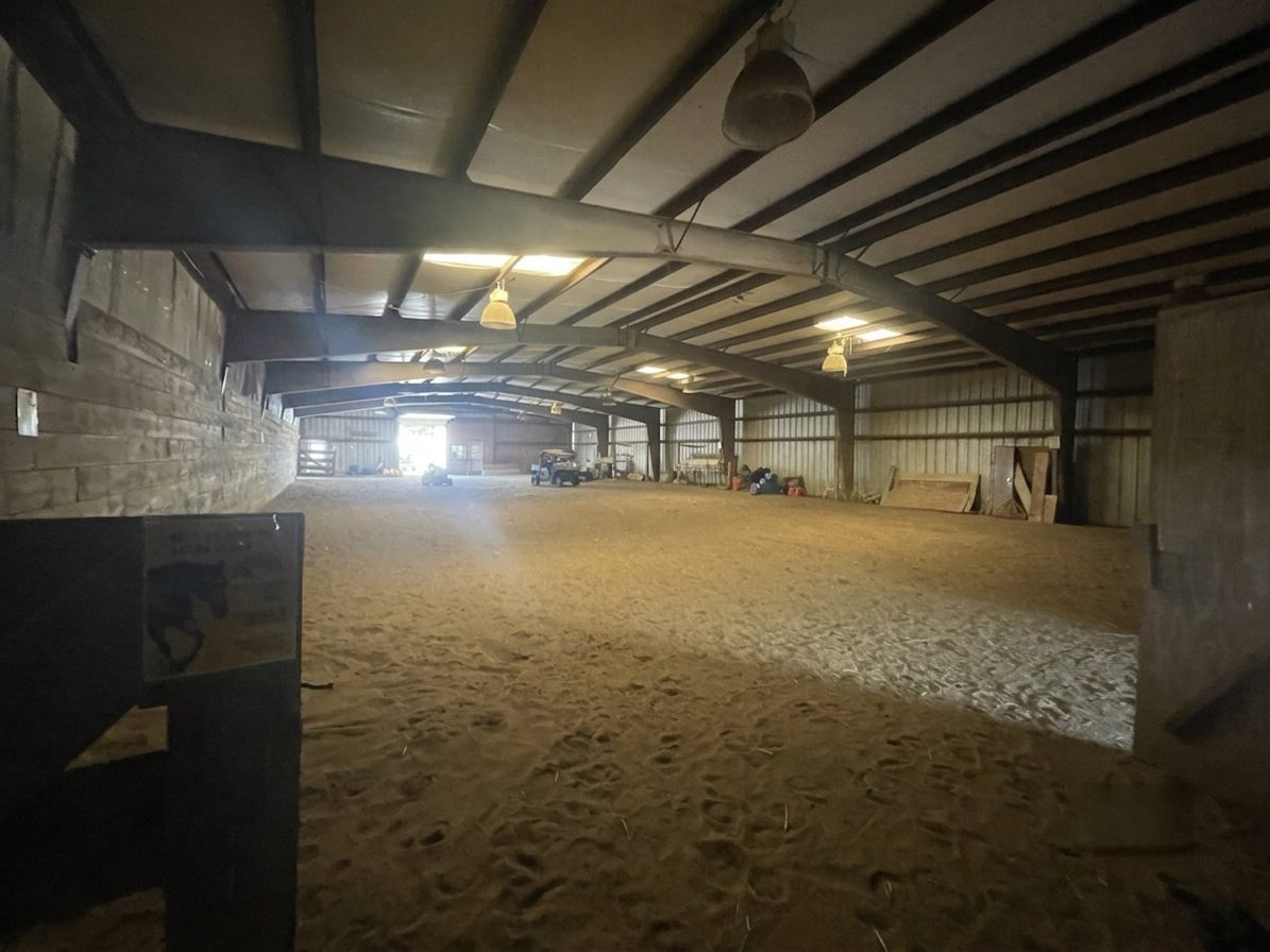 The large indoor riding arena with sand footing